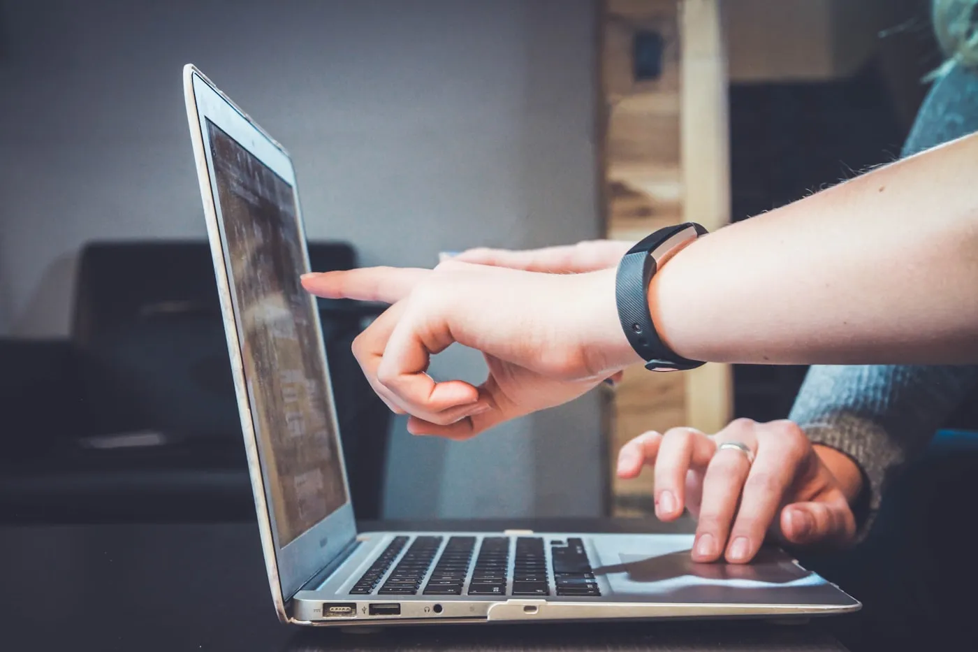 Two people reviewing work on a laptop