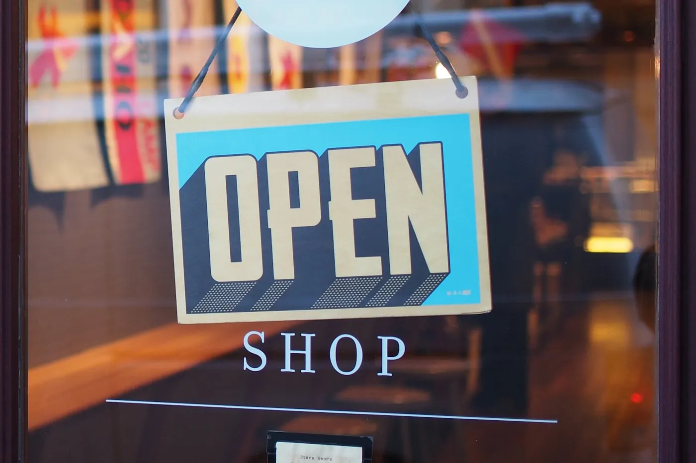 Open shop sign in a storefront window