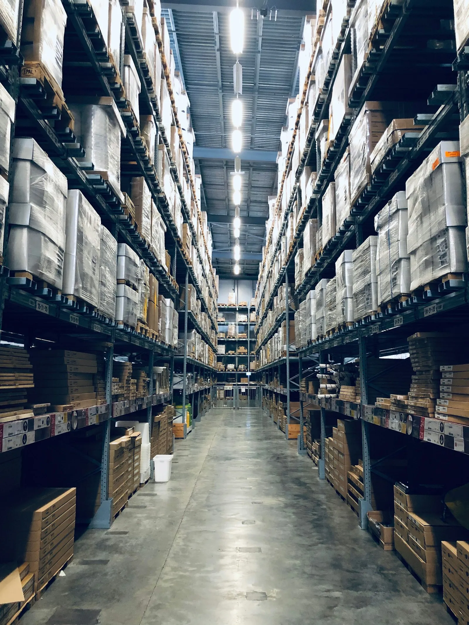 Aisles of pallet racking in a working warehouse